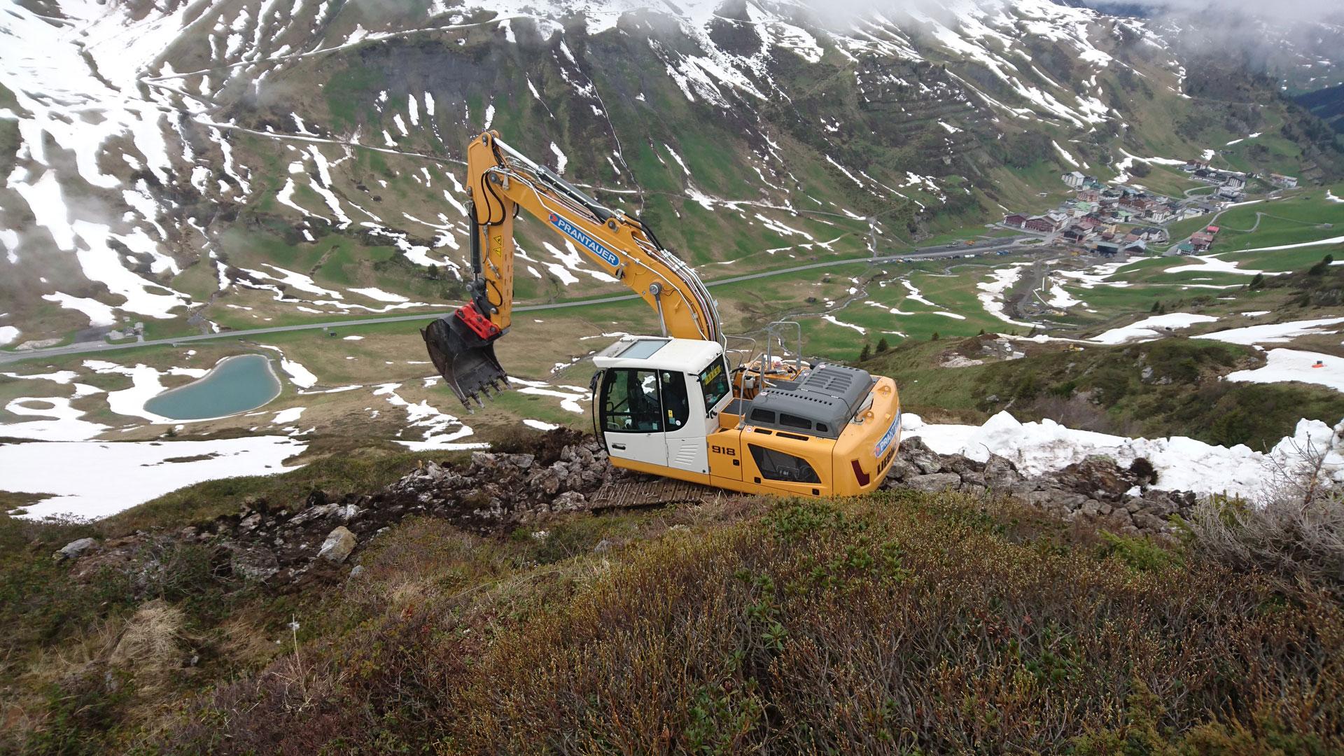 Bagger bei Erdbauarbeiten mit Blick ins Tal